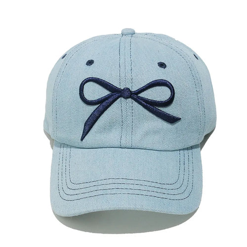 Light blue denim baseball cap with navy embroidered bow on the front