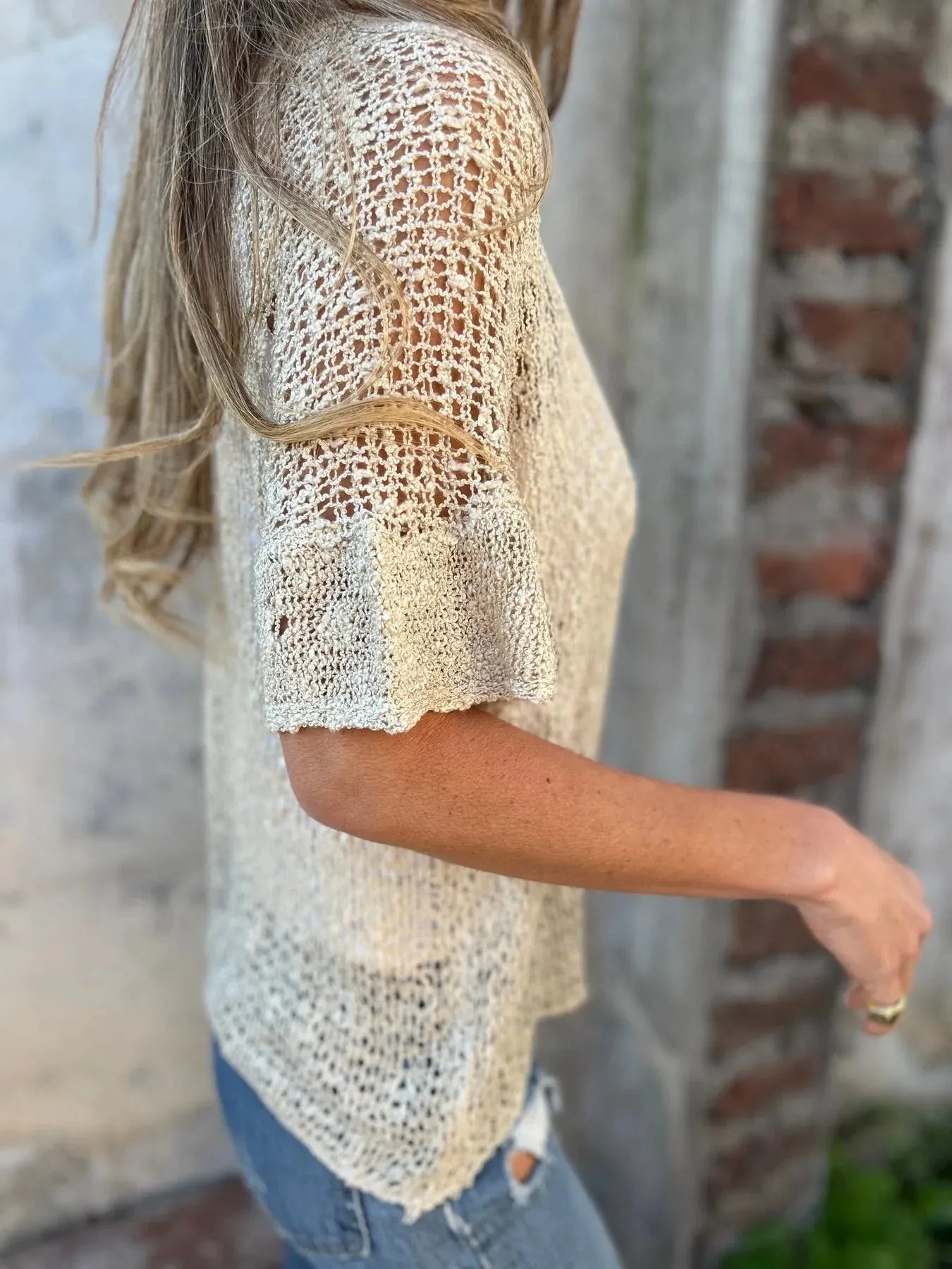 Light cream open-knit one-button half-sleeve cardigan, side view with V-neck