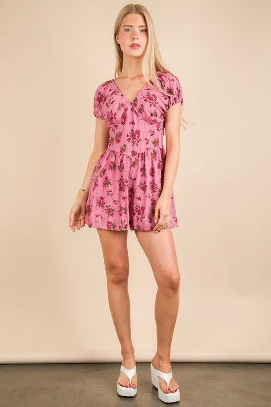 Pink floral ruffle-sleeve romper with V-neck and gathered waist, short shorts