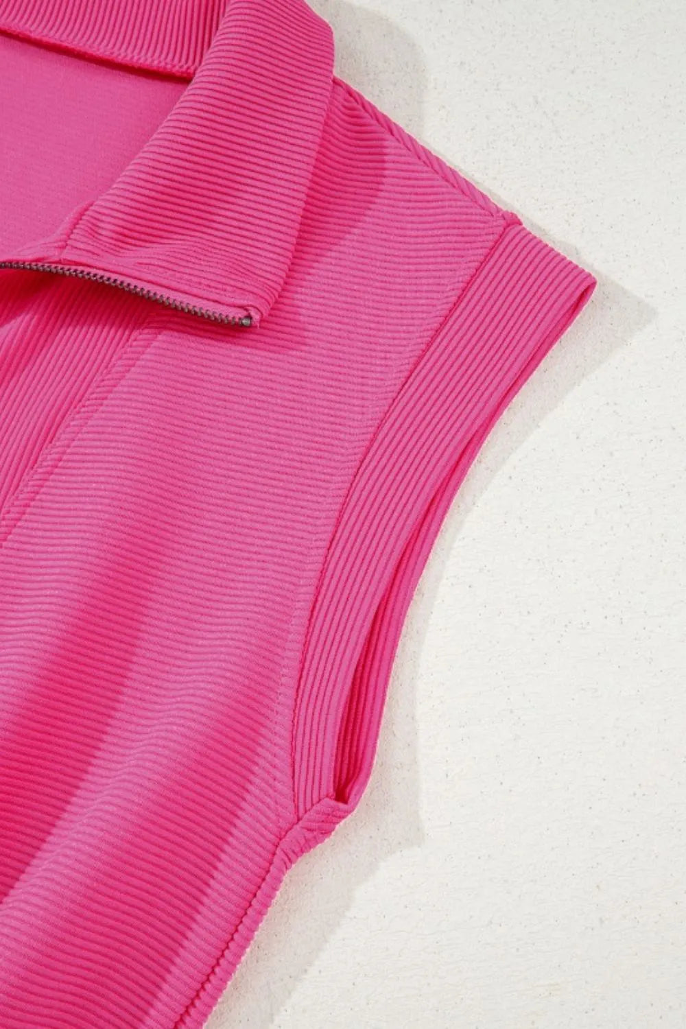 Hot pink textured romper sleeve and shoulder detail with ribbed fabric texture