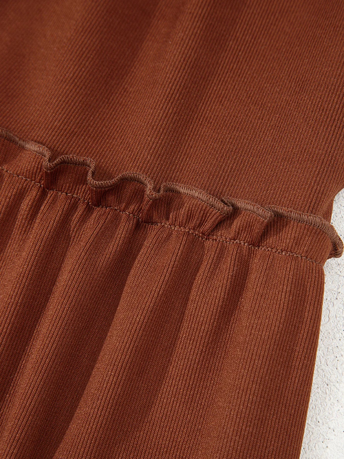 Frill Tiered Long Sleeve Mini Dress in rust rib-knit with ruffle trim.