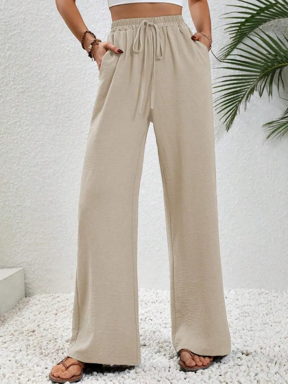 Cream wide-leg drawstring pants with elastic waist and flowy wide legs