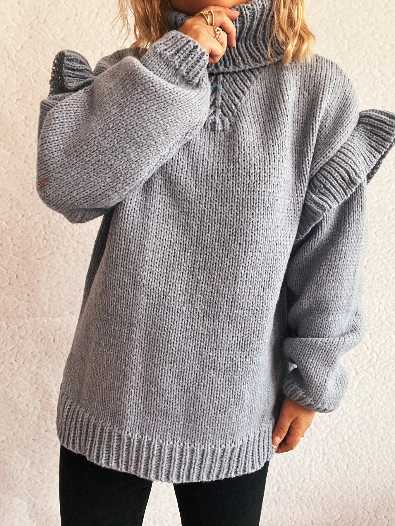 Grey ruffled turtleneck long-sleeve knit sweater with ribbed cuffs and hem