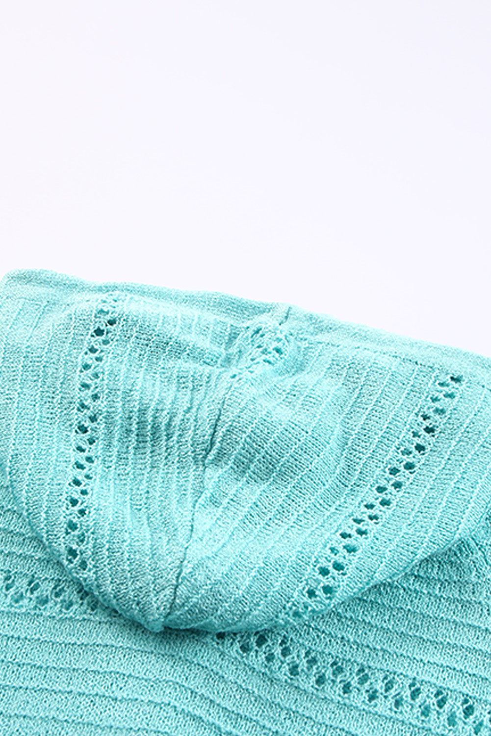 Turquoise knit cardigan hood close-up showing openwork panel stitching