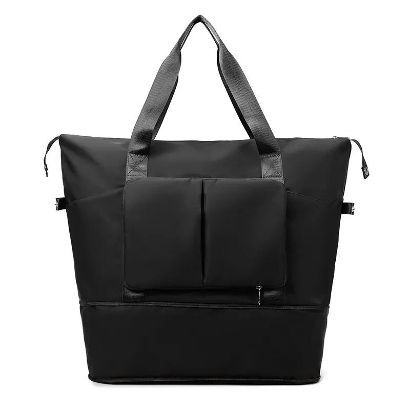 Black large duffel bag with front zip pocket organizer, top handles, and adjustable side straps.