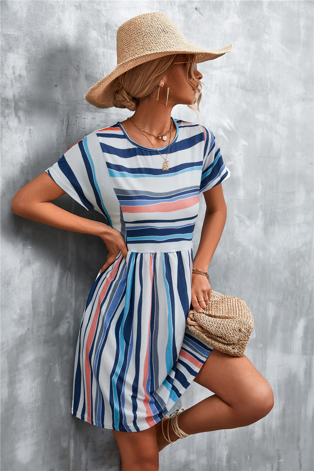 Striped round-neck dress with short sleeves, blue vertical stripes and coral accents, belted waist