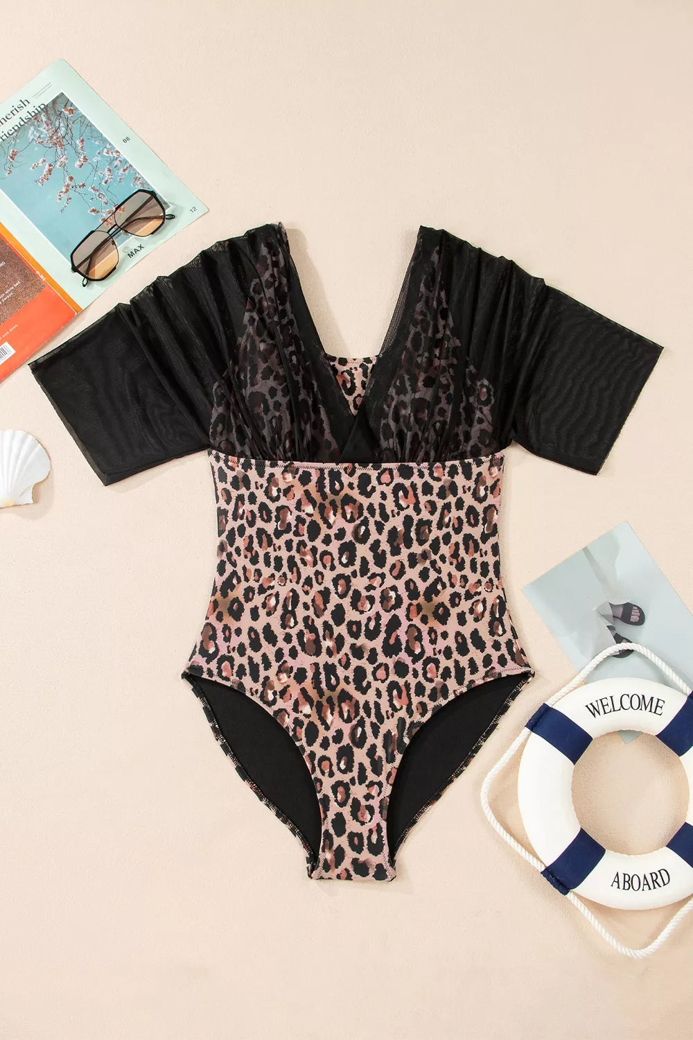 Leopard-print one-piece swimsuit with black mesh half sleeves; V-neck and cheeky cut.