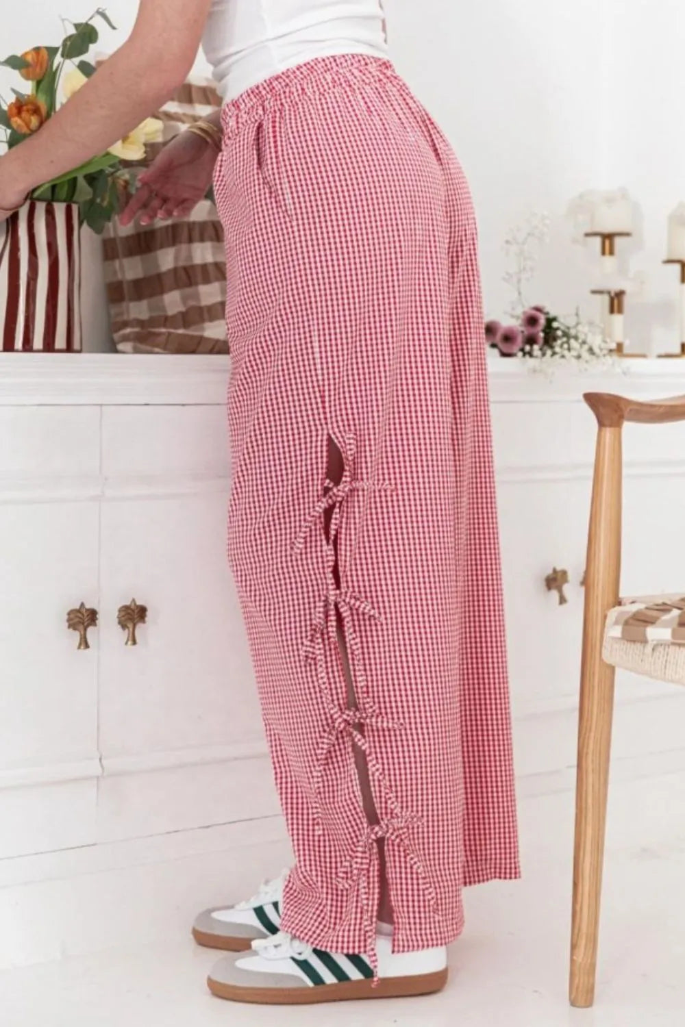Pink gingham wide-leg pants with ruched side ties and pocket opening