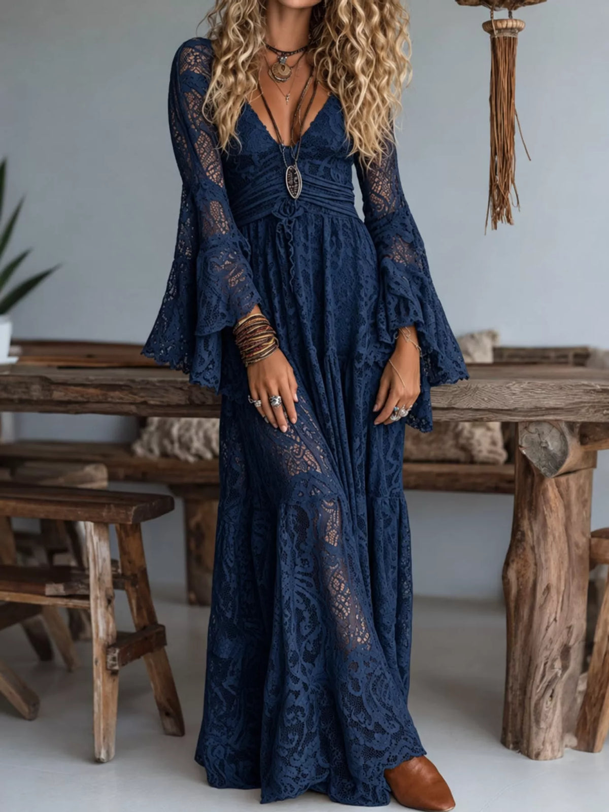 Navy lace maxi dress with ruched V-neck and long flared sleeves, ornate floral trim.