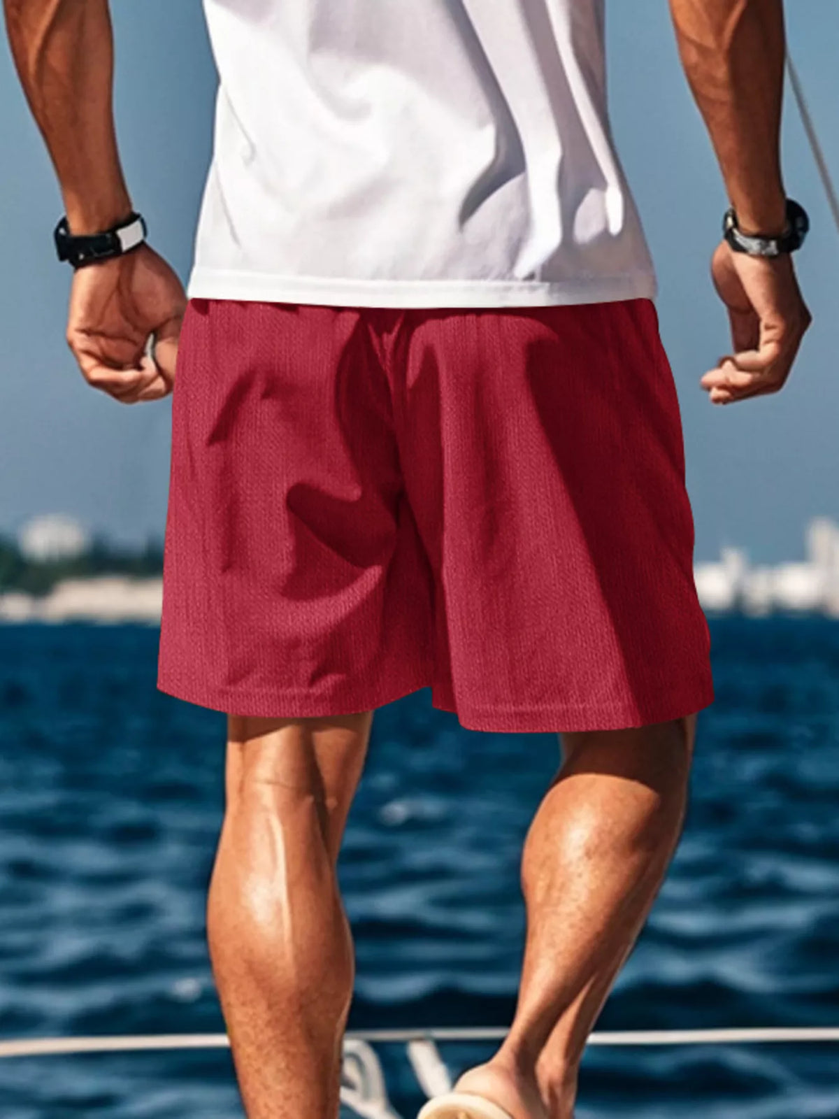 Men's red mid-length drawstring shorts with side pockets