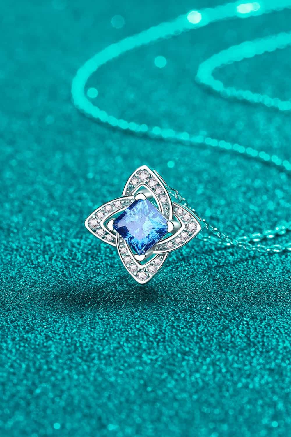 Silver-tone pendant necklace with sky-blue square-cut stone in double halo setting
