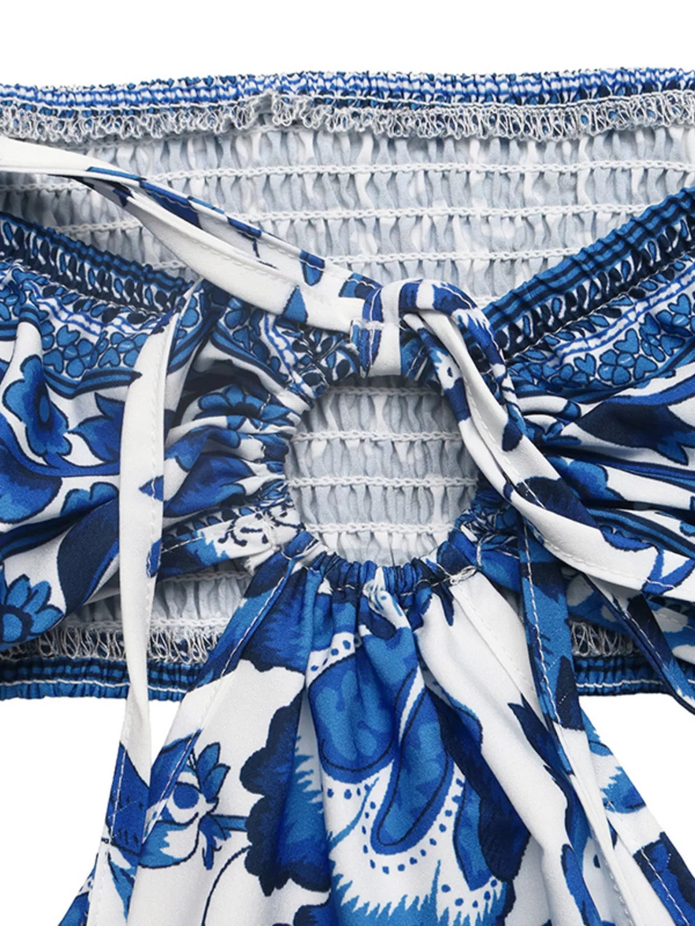 Cedar & Moore Floral Print Halter Neck Cutout Mini Dress with smocked, tied detailing in blue and white.