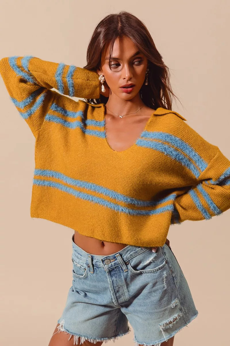 Mustard fuzzy sweater with deep U neck, light blue striped bands across chest and sleeves