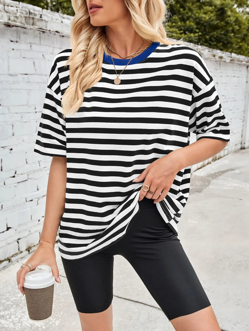 Black striped round-neck half-sleeve T-shirt with loose drape, front view.