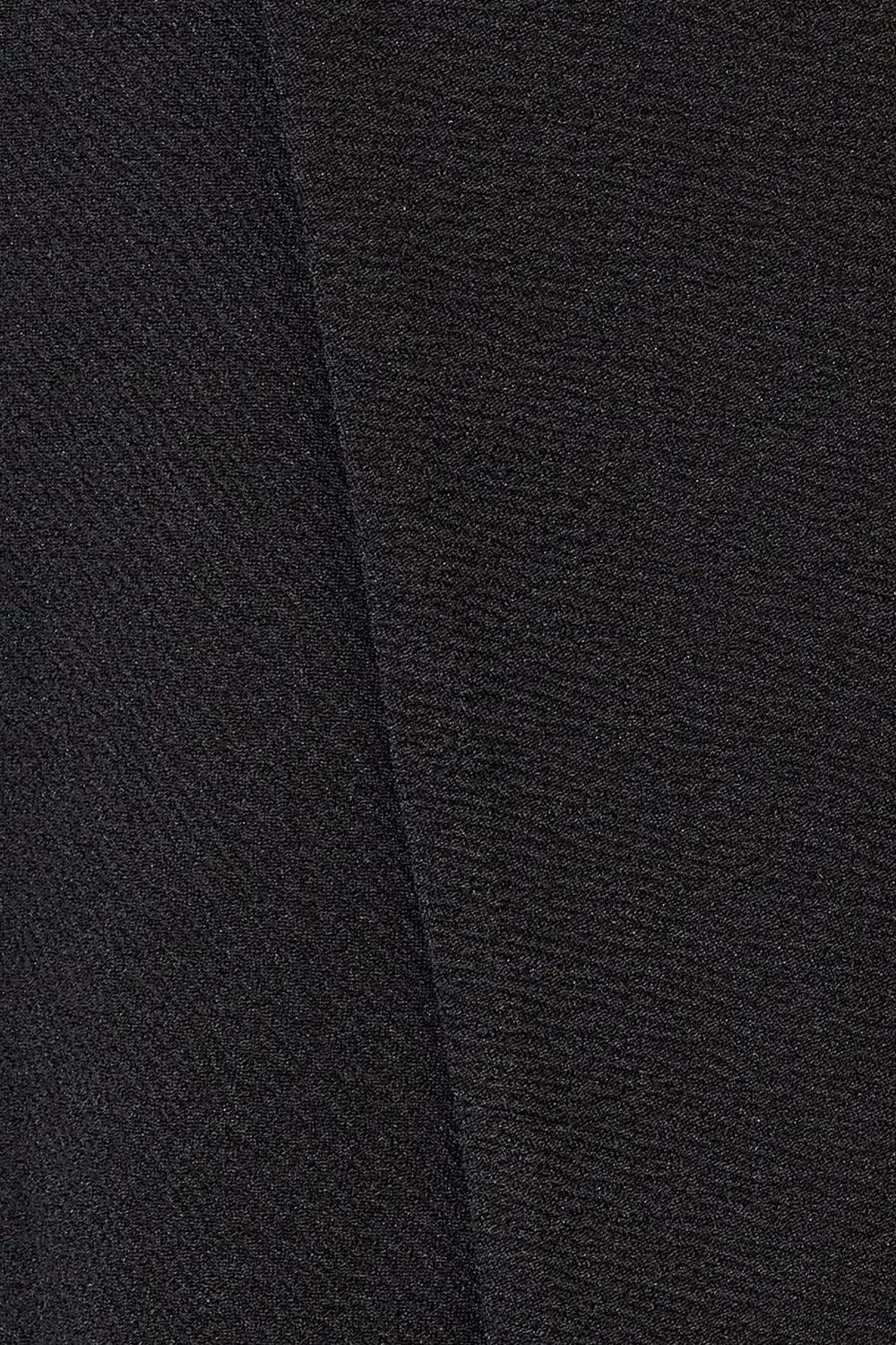 Black blazer fabric close-up with subtle textured weave
