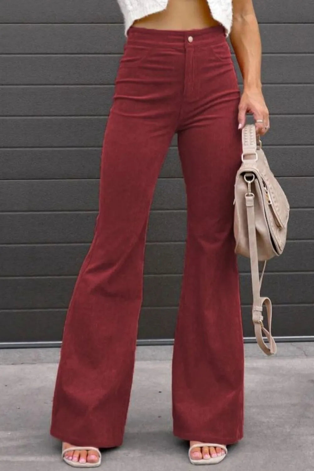 High-waist bootcut pants in burgundy with front button and side pockets