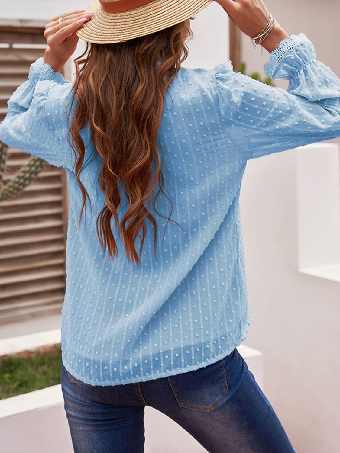 Light blue swiss dot blouse with long balloon sleeves and lace V-neck