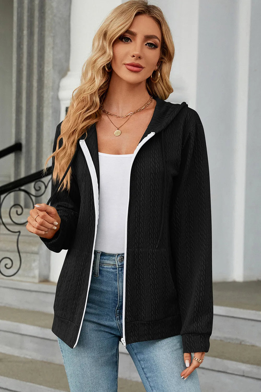 Black drawstring zip-up hoodie with hooded neckline and white-trim front zipper