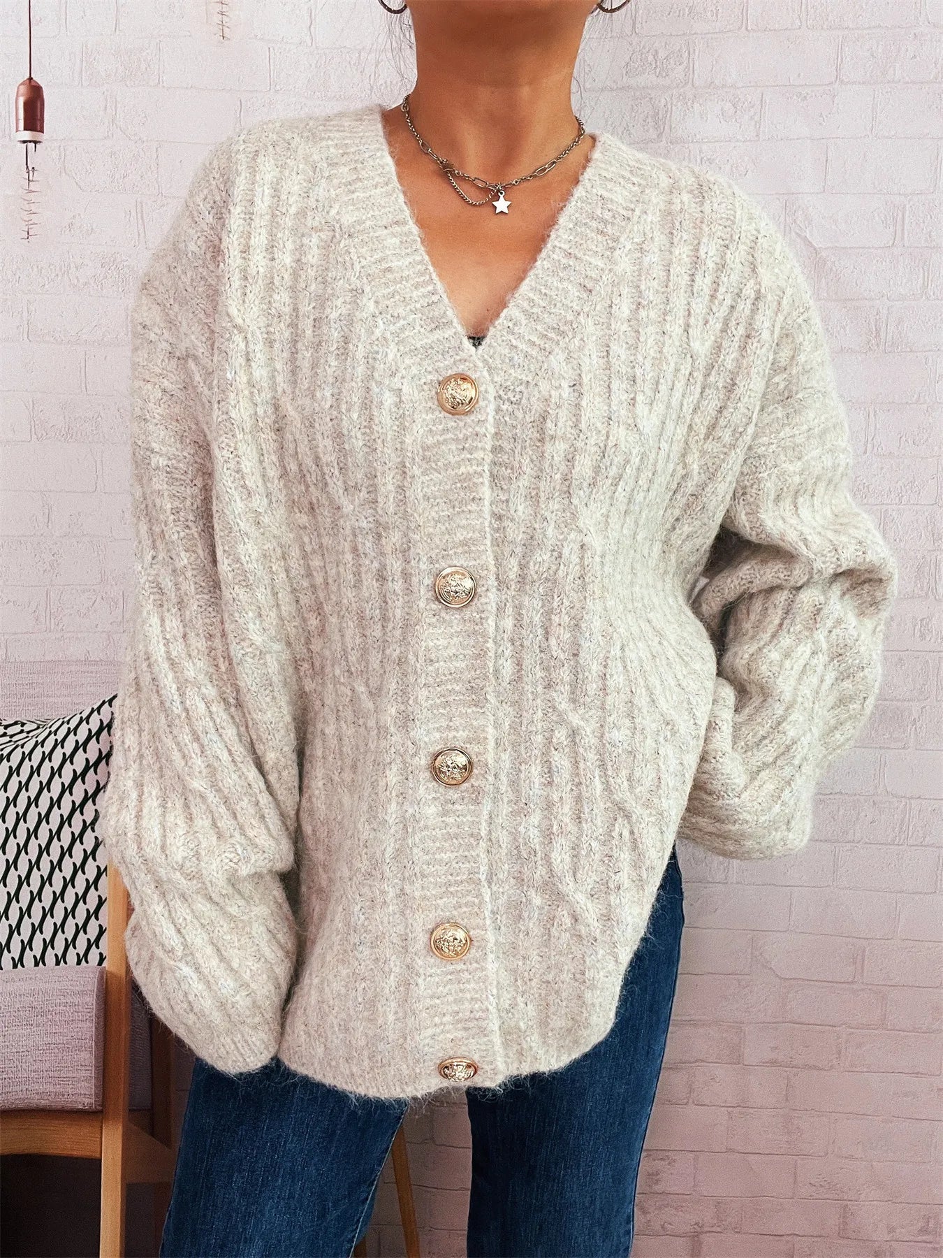 Cream cable knit button-up cardigan with V-neck and gold-tone front buttons