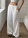White relaxed wide-leg drawstring pants with elastic waistband and gathered cuffs