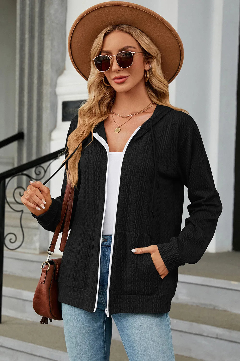 Black drawstring zip-up hoodie with hood, white-trim zipper, and front kangaroo pocket
