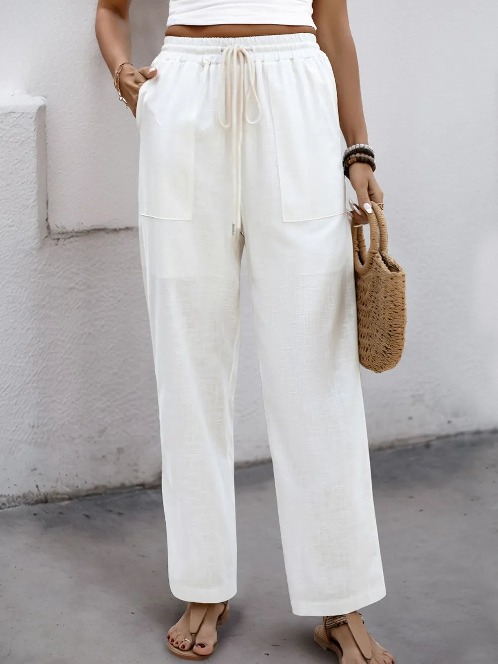 White drawstring wide-straight pants with elastic waist and side pockets