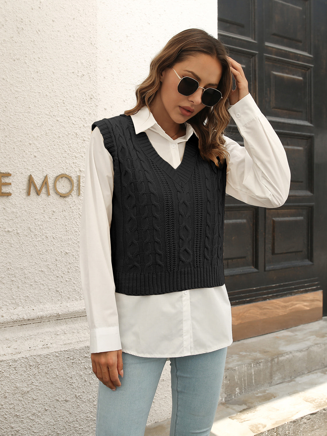 Black V-neck textured knit sweater vest with cable-style knit detail