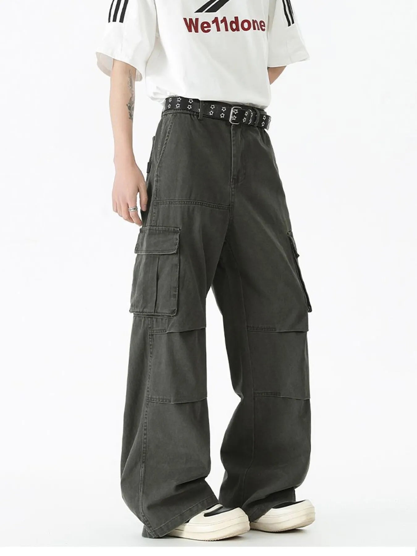 Dark green wide-leg cargo pants with side cargo pockets and studded waist belt