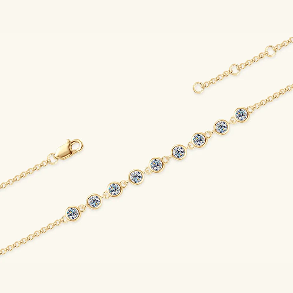 Gold-tone bracelet with evenly spaced round blue stones and chain clasp