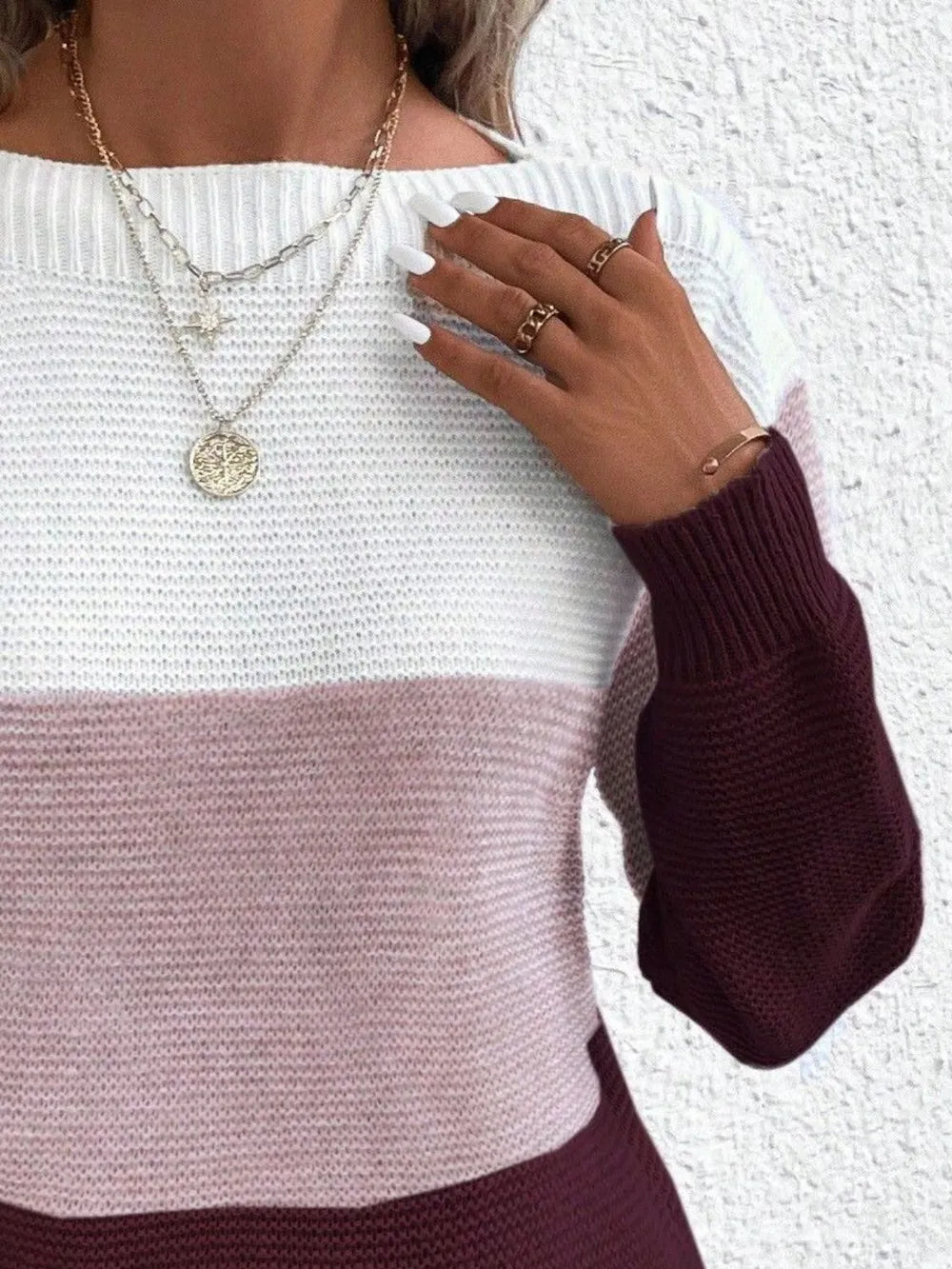 Color-block boat neck sweater in white with dusty pink band and burgundy sleeve.