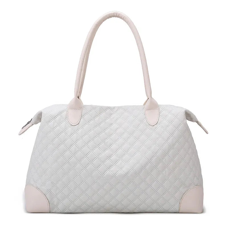 Light beige quilted travel bag with top handles and zip closure