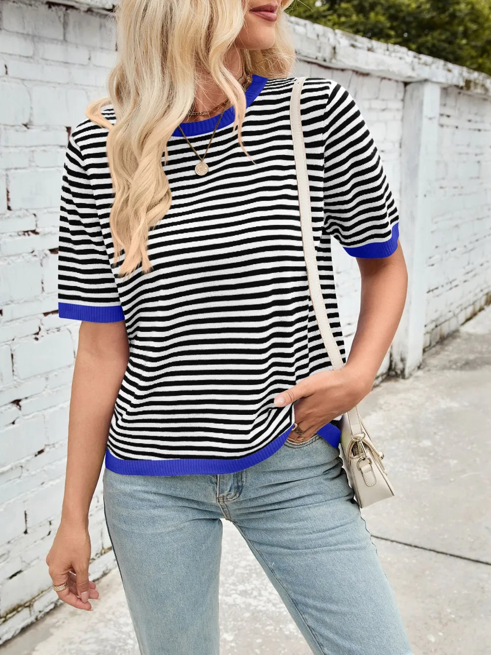 Striped knit top, black-and-white stripes with blue ribbed trim at neckline and cuffs