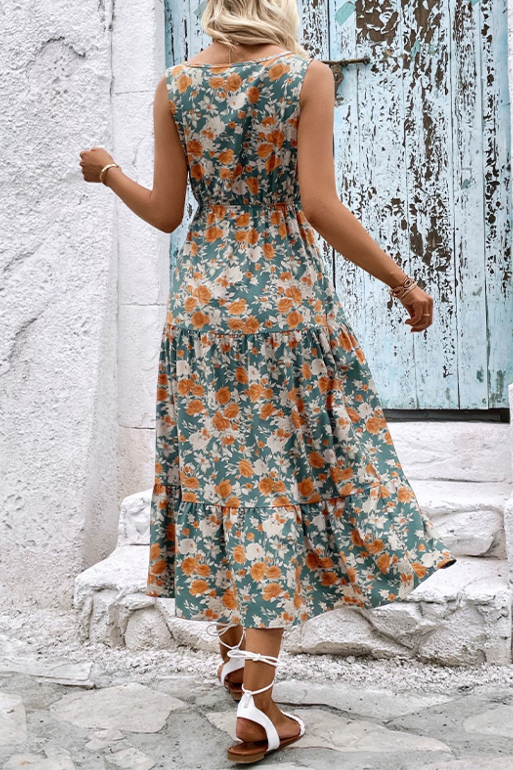 Floral tiered sleeveless midi dress with V-neck front, orange and teal flower print.