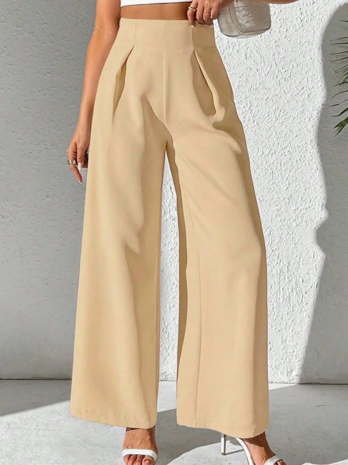 Beige high-waist wide-leg pants with pleated front and wide hem