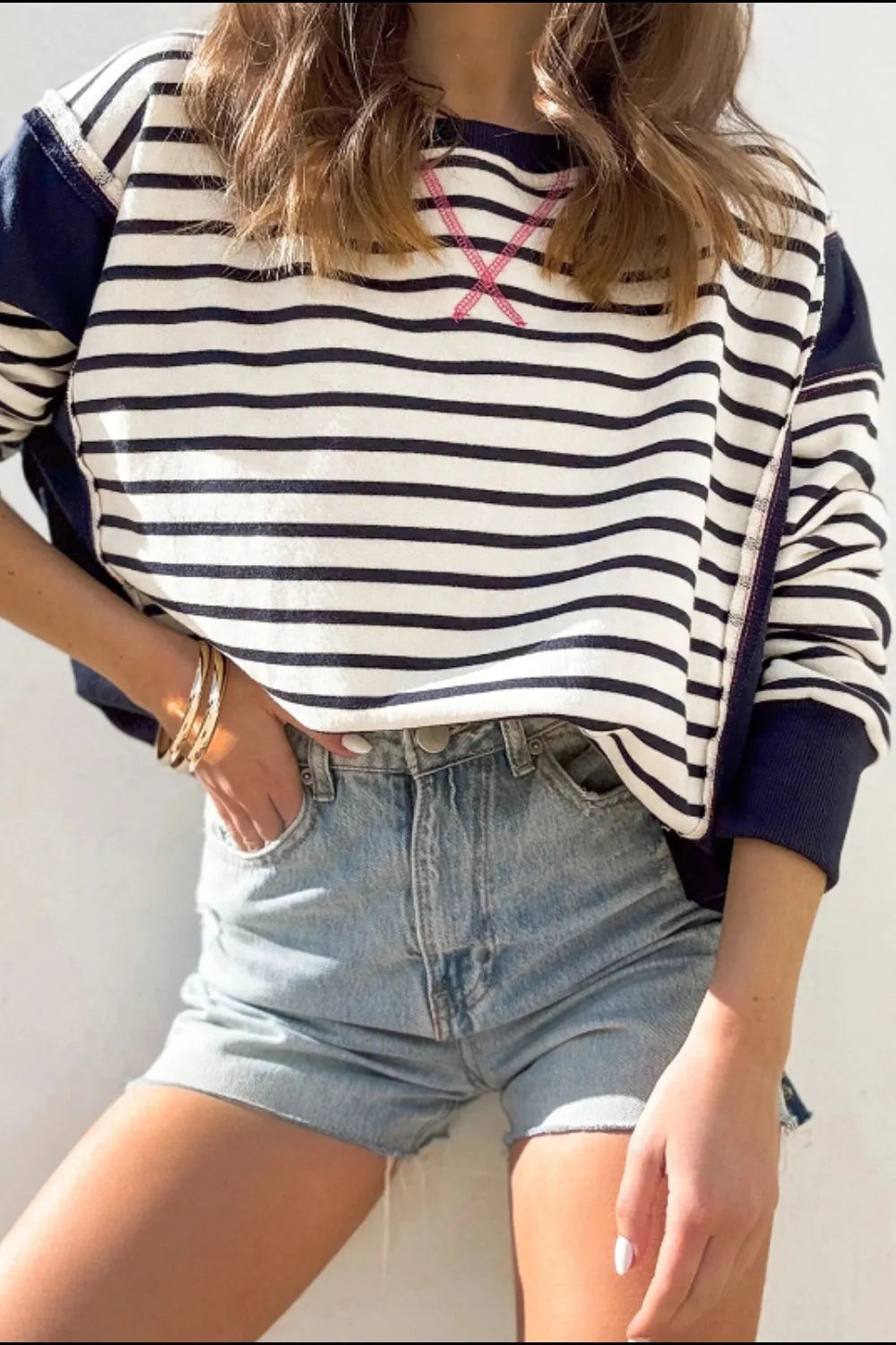 Striped long sleeve sweatshirt with exposed seam, navy/white stripes and pink neckline stitch