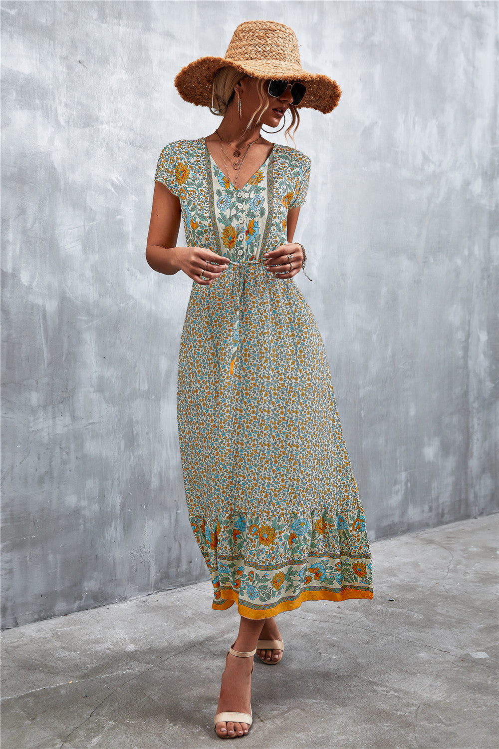 V-neck printed maxi dress with short sleeves, beige base, teal and orange floral border.