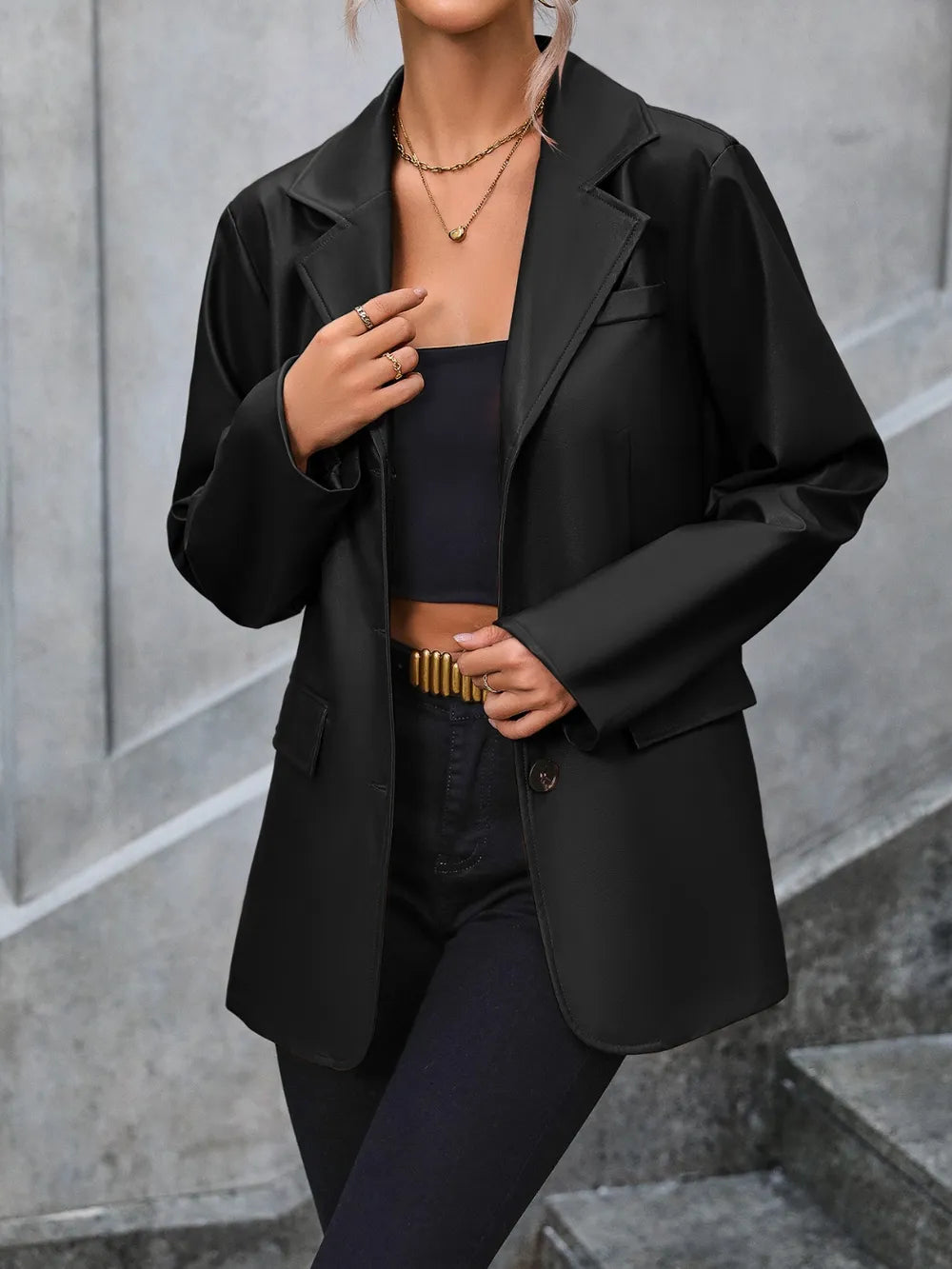Black button-up blazer with collared neckline, flap pockets, and button front
