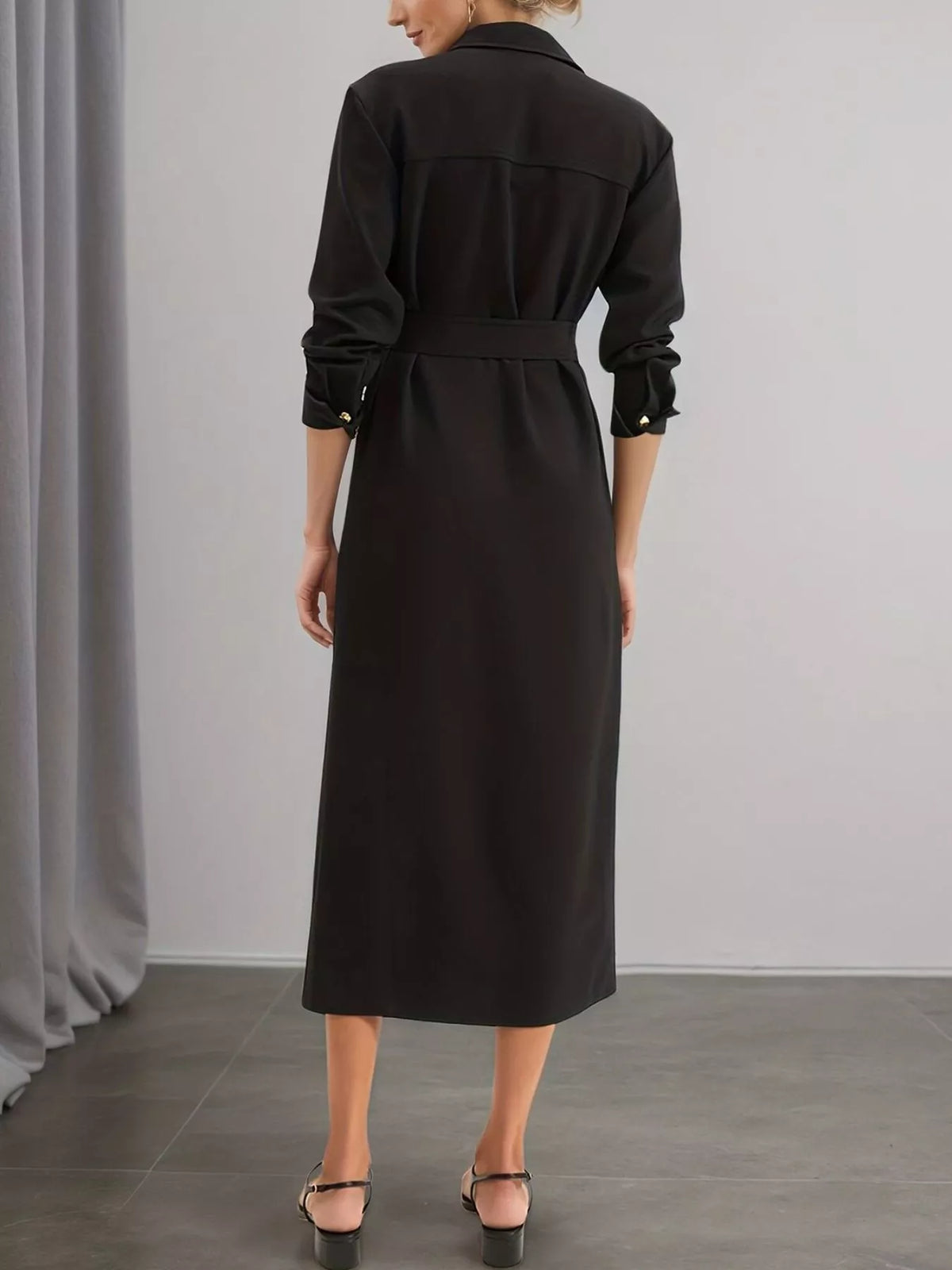 Back view black belted midi dress with long sleeves and waist tie