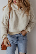Beige fuzzy dropped-shoulder long-sleeve hoodie with hood and ribbed cuffs, worn with jeans