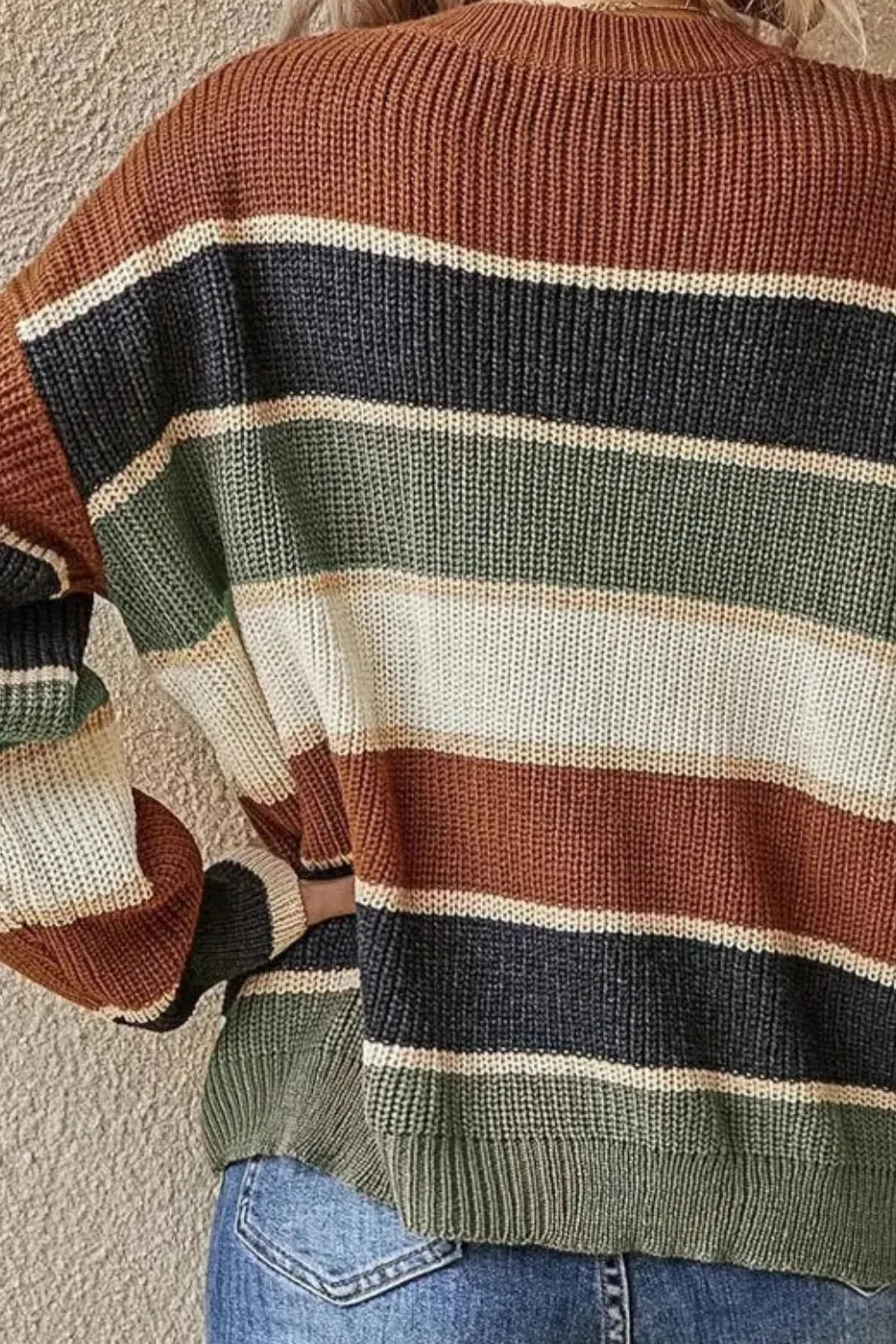 Striped sweater back with brown, navy, cream, and olive-green horizontal bands