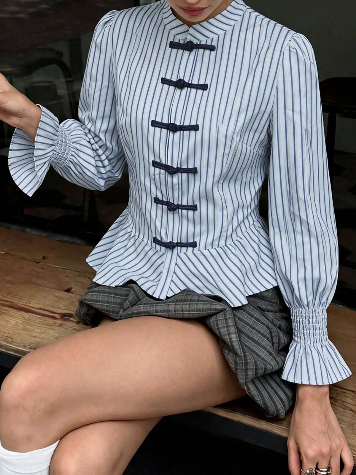 Womens blue striped mandarin peplum knot shirt with black bow-tie details and elastic cuffs