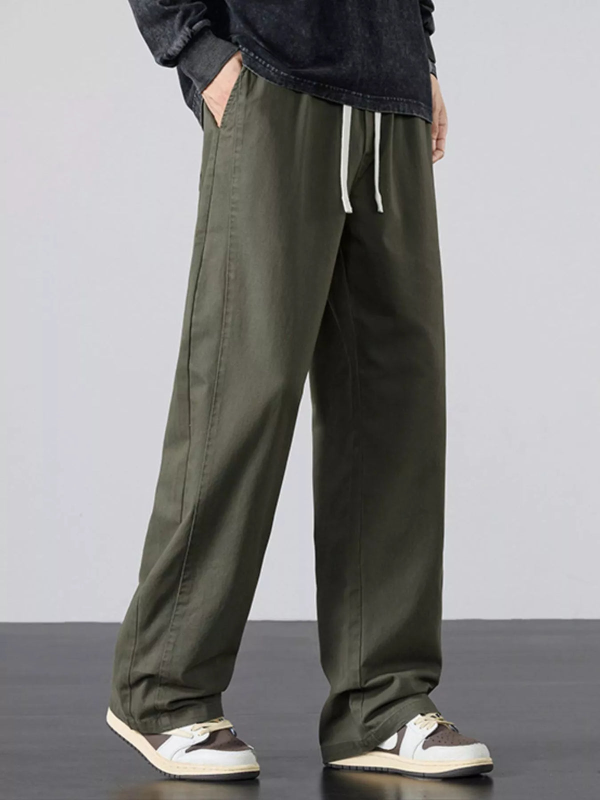 Mens army green wide-leg drawstring pants with relaxed fit and side seam pockets