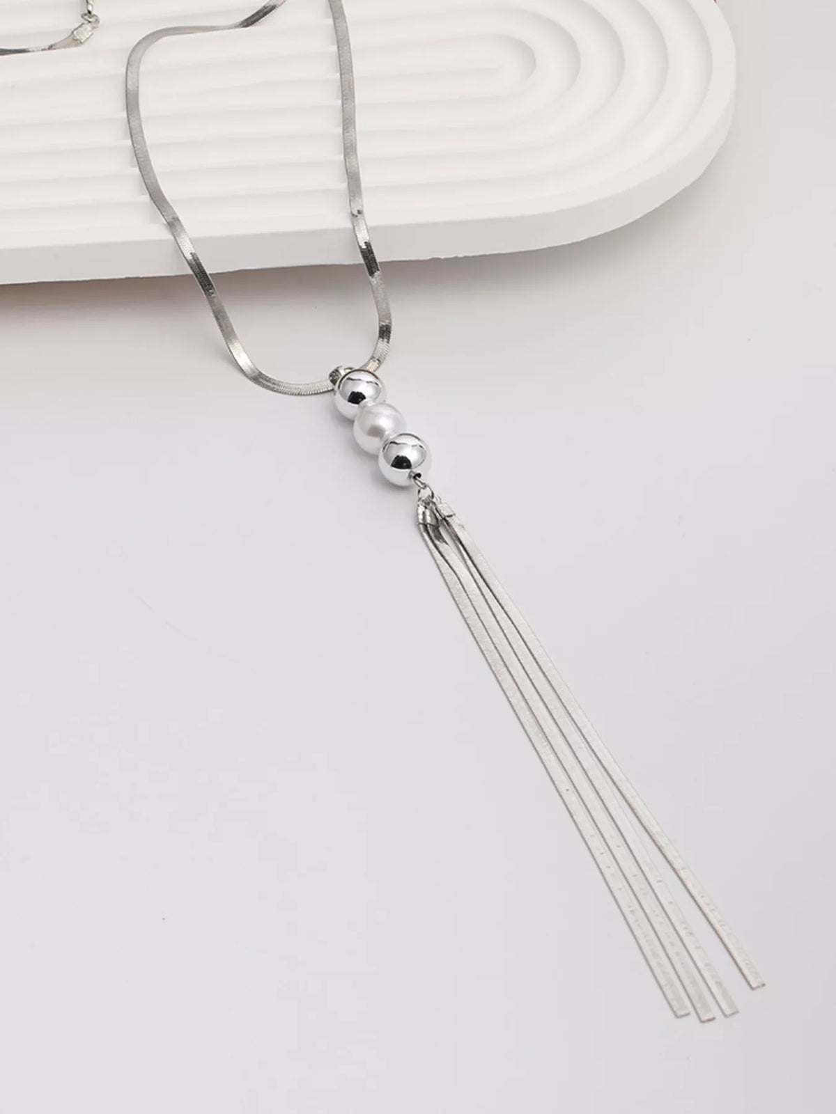 Silver bead and tassel pendant necklace with spherical beads and triple tassel