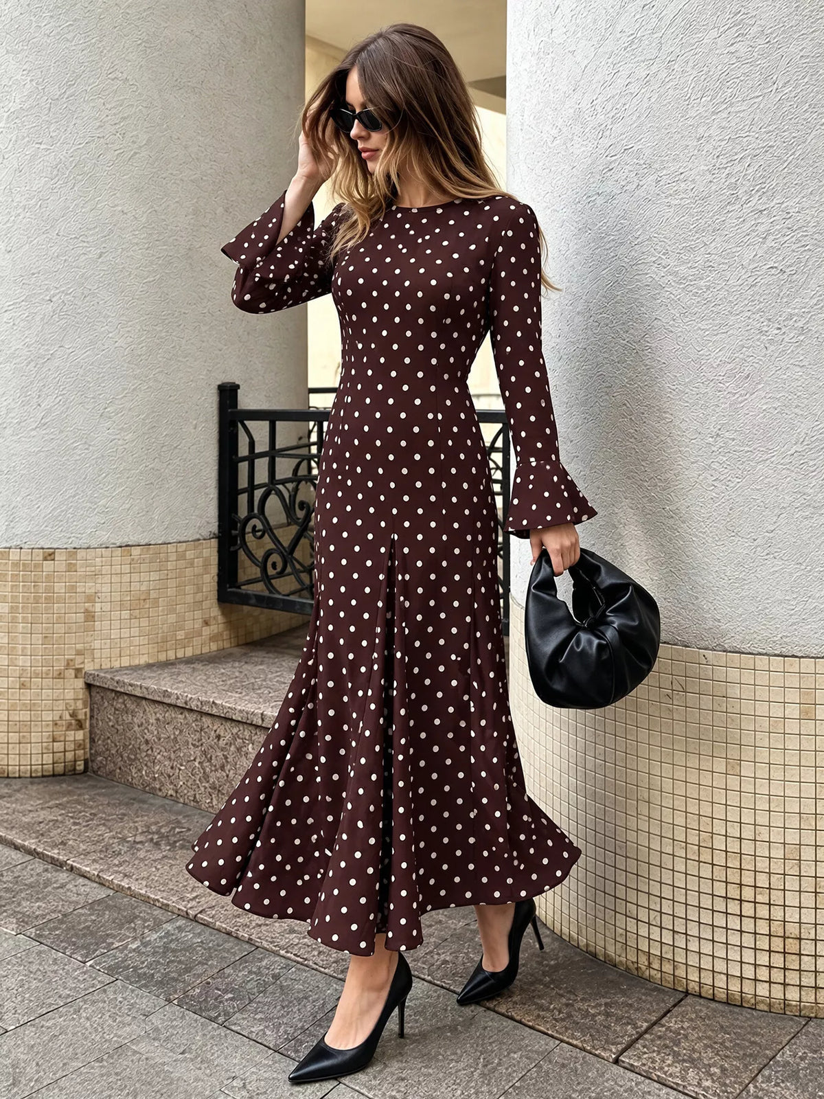 Coffee brown polka dot long-sleeve maxi dress, angled view with flared skirt