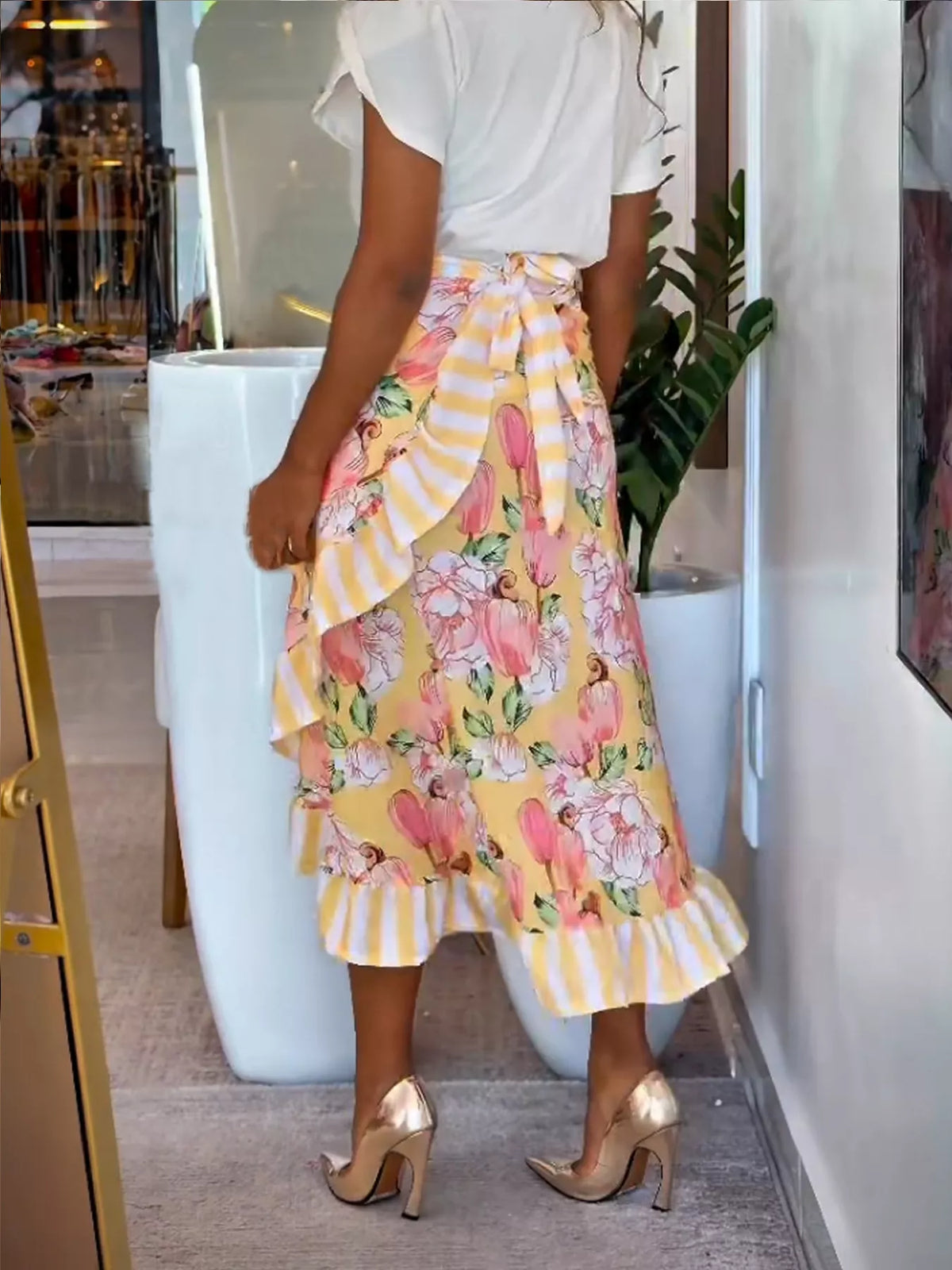 Yellow floral midi skirt with ruffle hem, tiered layers, and asymmetrical shape