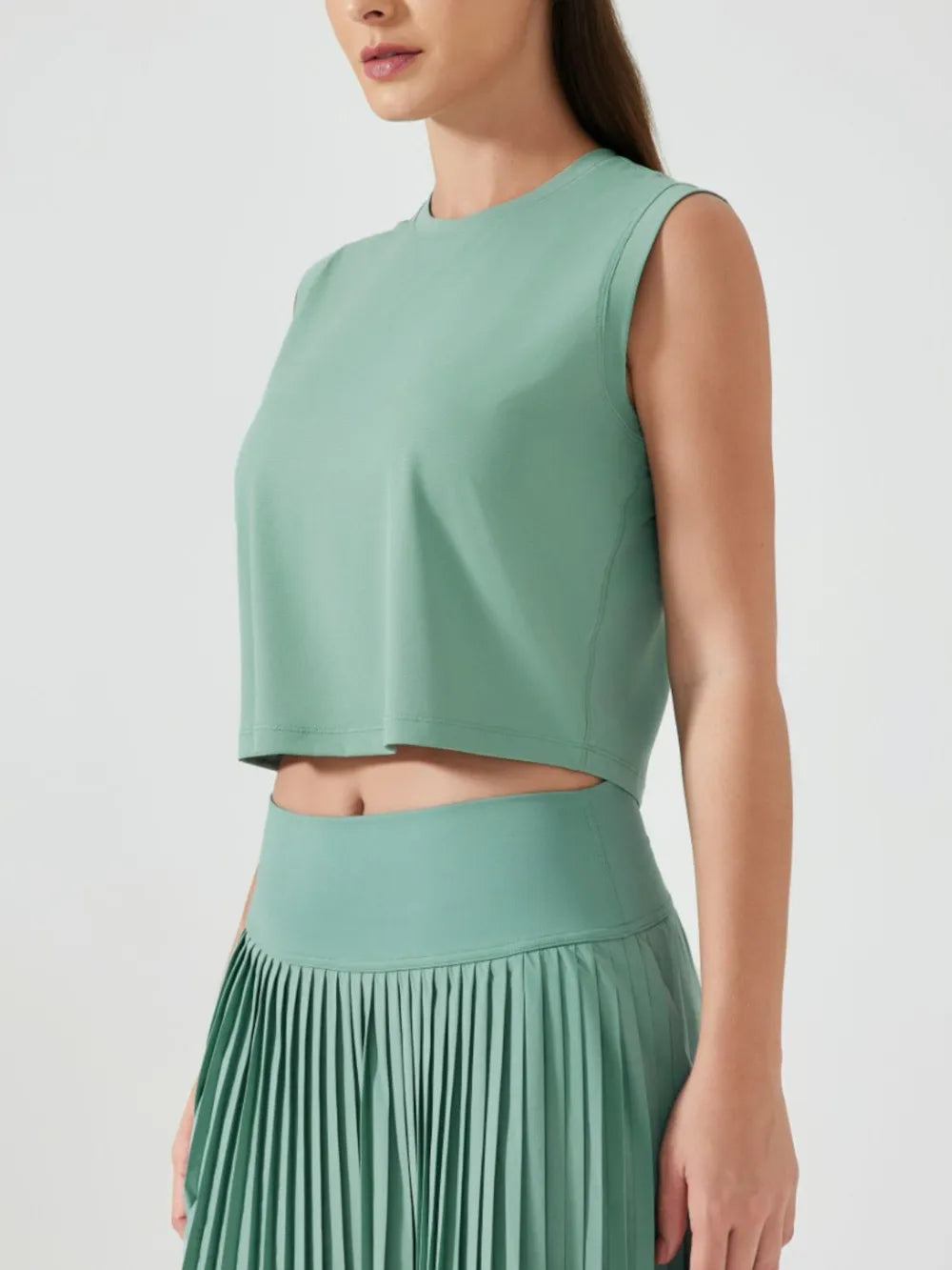 Millennia cropped active tank, sleeveless with round neck, teal green.