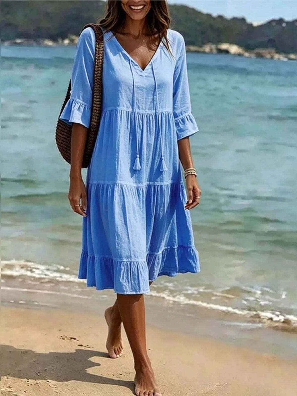 Light blue tiered tie-neck flounce sleeve dress with tassel detail and V neckline