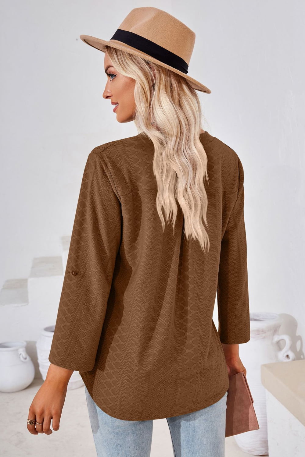 Brown V-neck roll-tap sleeve blouse with textured fabric and side-slit hem, 3/4 sleeves