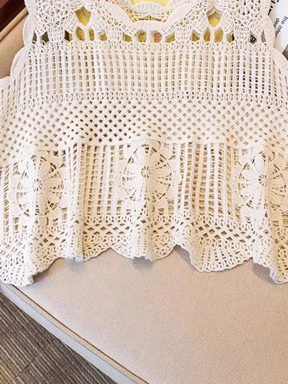 Cream openwork scoop-neck tank close-up with grid crochet pattern and scalloped hem