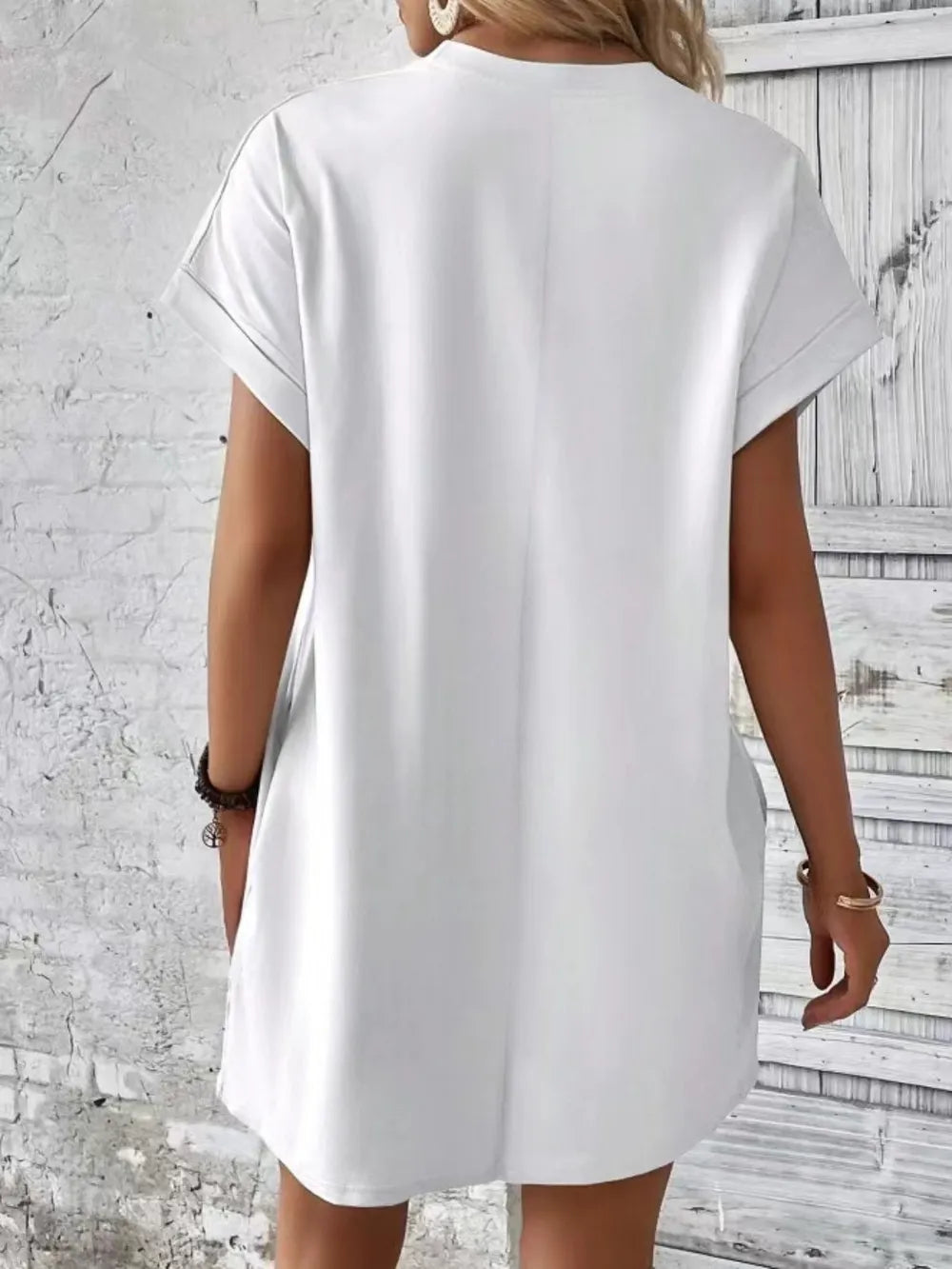 White pocketed round-neck short-sleeve dress, back view, relaxed fit and side pockets
